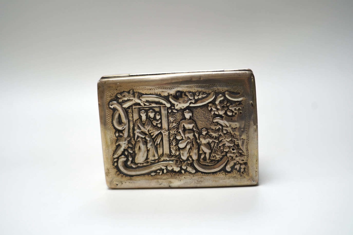 A late 19th century Dutch embossed white metal rectangular snuff box, 83mm, 107 grams. Condition - poor